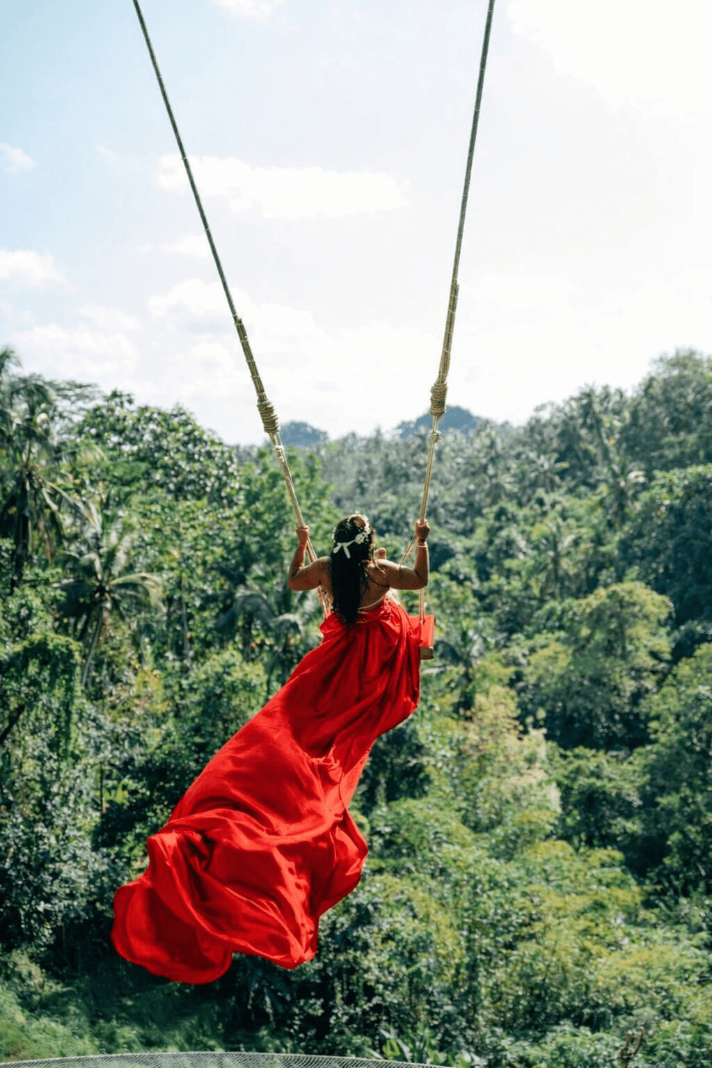 Bali jungle swing experience with lush greenery and ocean views